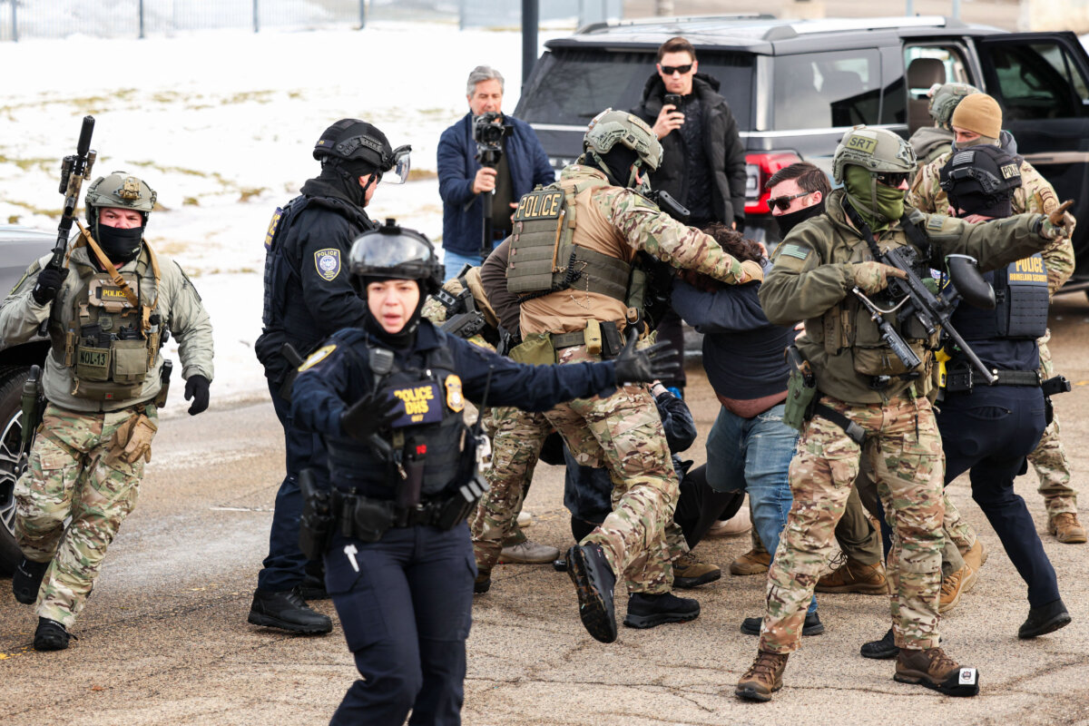 Federal agents detain a protester near the Bishop Henry Whipple Federal Building in Minneapolis on Jan. 9, 2026. (Charly Triballeau/AFP via Getty Images)