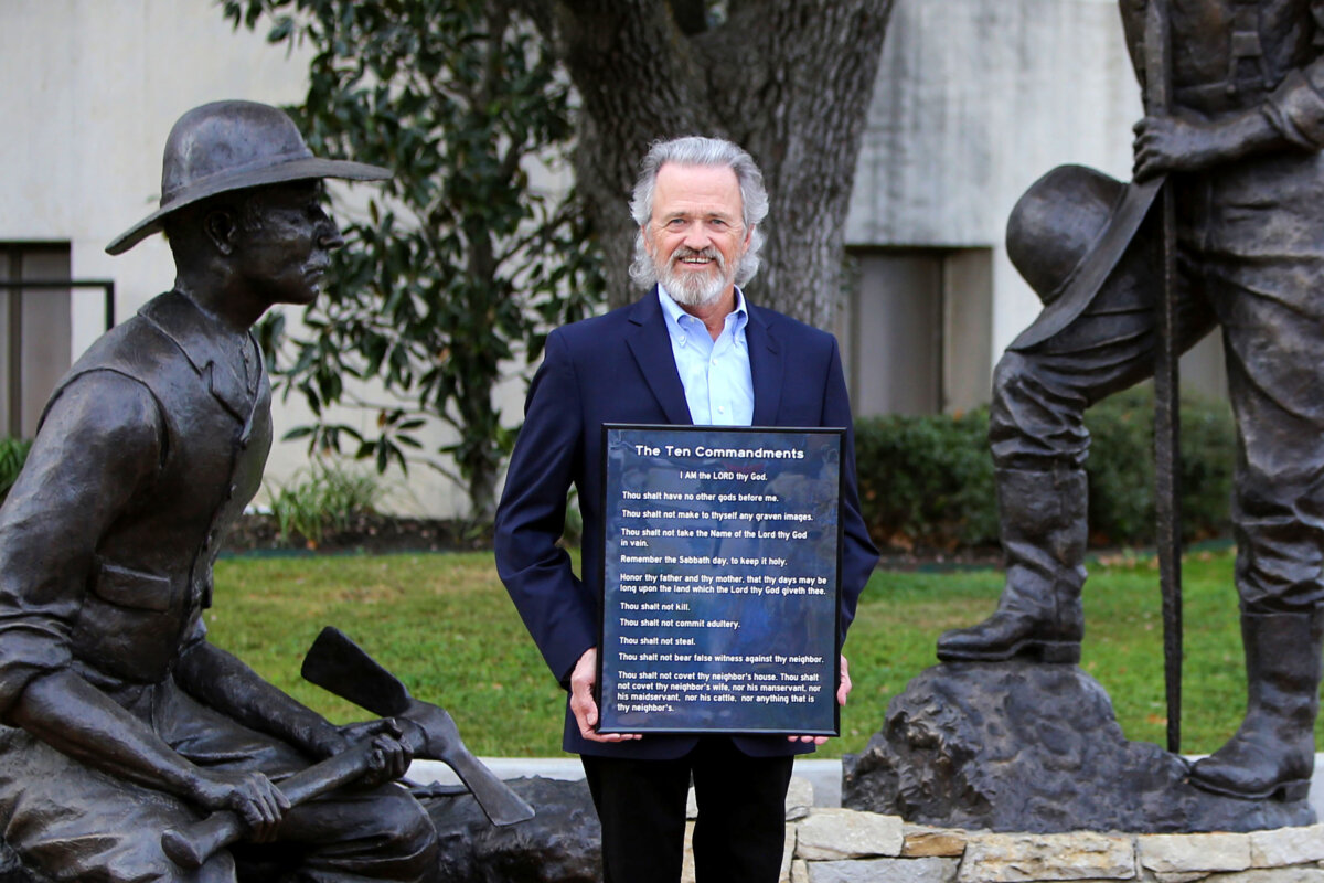 Lorne Liechty poses with a copy of the Ten Commandments in Rockwall, Texas, on Jan. 8, 2026. He and his family donated copies to hang in Rockwall schools. (Bobby Sanchez for The Epoch Times)