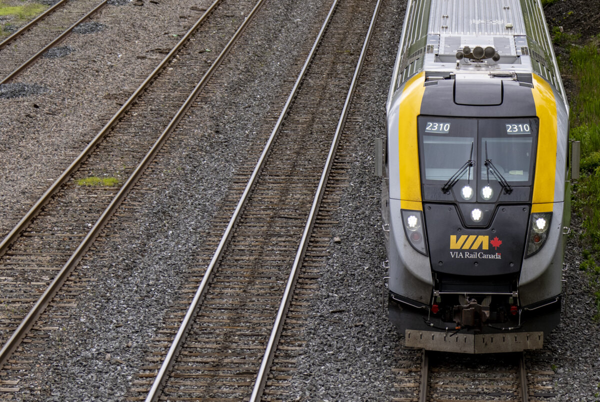 A Via Rail train is seen on tracks in Dorval, Que., as it heads out of Montreal on May 23, 2025. (The Canadian Press/Christinne Muschi)