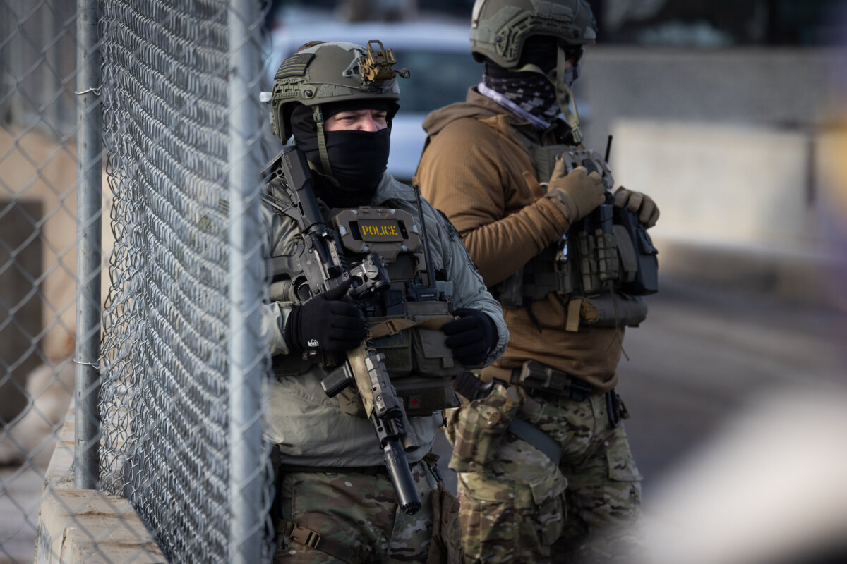 Immigration and Customs Enforcement (ICE) agents confront protestors in front of the Bishop Henry Whipple Federal Building in Minneapolis, Minn., on Jan. 12, 2026. (John Fredricks/The Epoch Times)