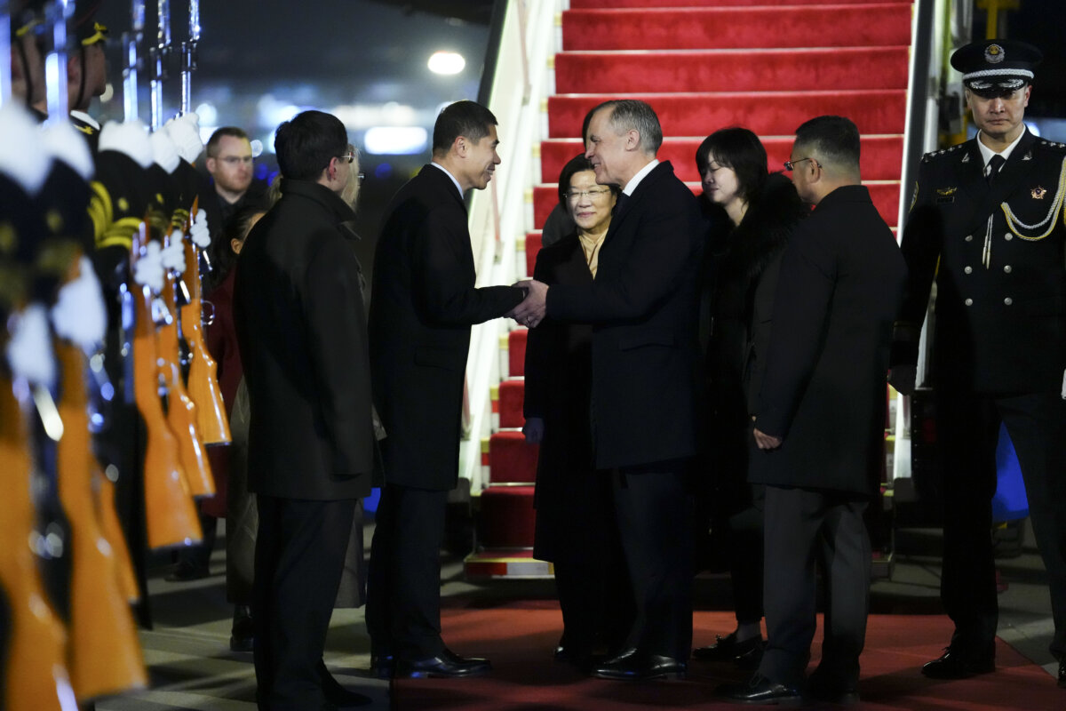Prime Minister Mark Carney shakes hands with Chinese Ambassador to Canada Wang Di as he is officially welcomed to Beijing on Jan. 14, 2026. (The Canadian Press/Sean Kilpatrick)