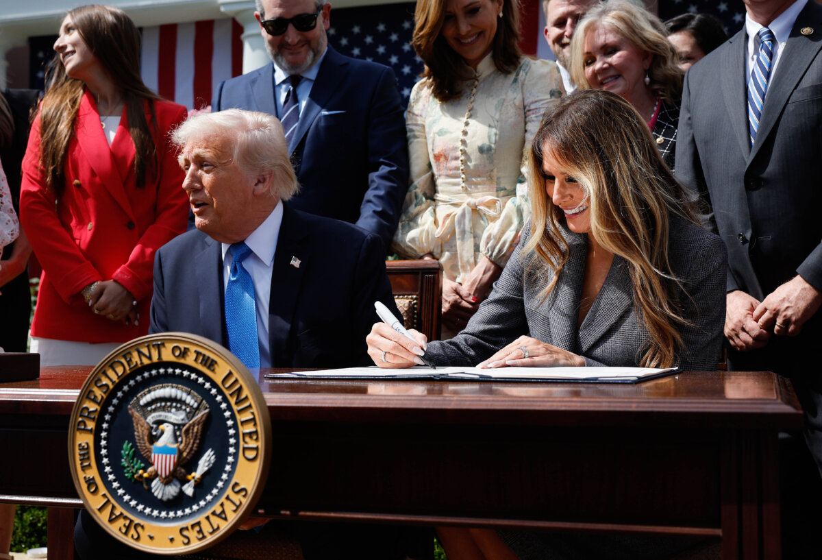First Lady Melania Trump signs the Take It Down Act alongside President Donald Trump, lawmakers, and victims of artificial intelligence-generated deepfakes and revenge porn, during a signing ceremony in the Rose Garden of the White House on May 19, 2025. (Chip Somodevilla/Getty Images)