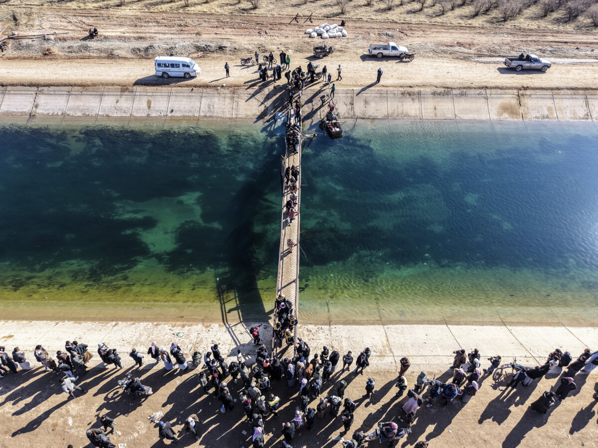 People fleeing from a Kurdish-controlled area, in Rasm al-Harmal, in eastern Aleppo, Syria, on Jan. 16, 2026. (Abdulmonam Eassa/Getty Images)