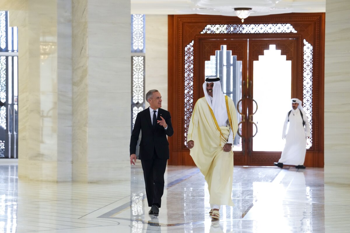 Prime Minister Mark Carney walks with Emir of Qatar Tamim bin Hamad Al Thani at Amiri Diwan in Doha, Qatar, on Jan. 18, 2026. (The Canadian Press/Sean Kilpatrick)