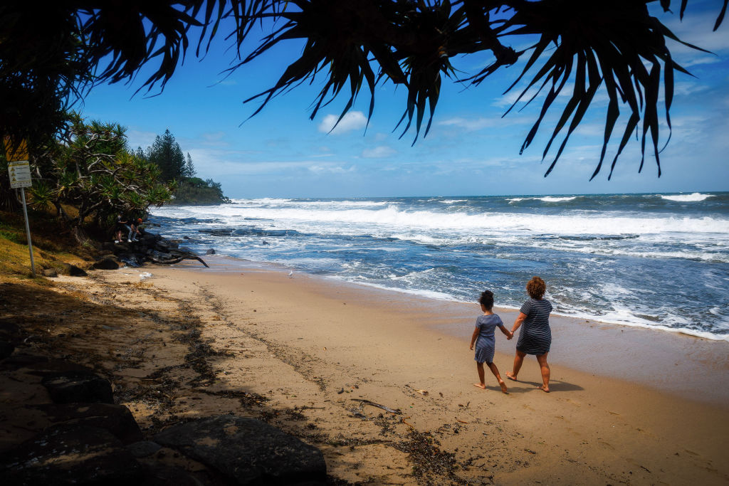 Tourist's watch high waves as they walk along Kings Beach, Caloundra on the Sunshine Coast, north of Brisbane, Australia on March 6, 2025. (Patrick Hamilton/AFP /AFP via Getty Images)