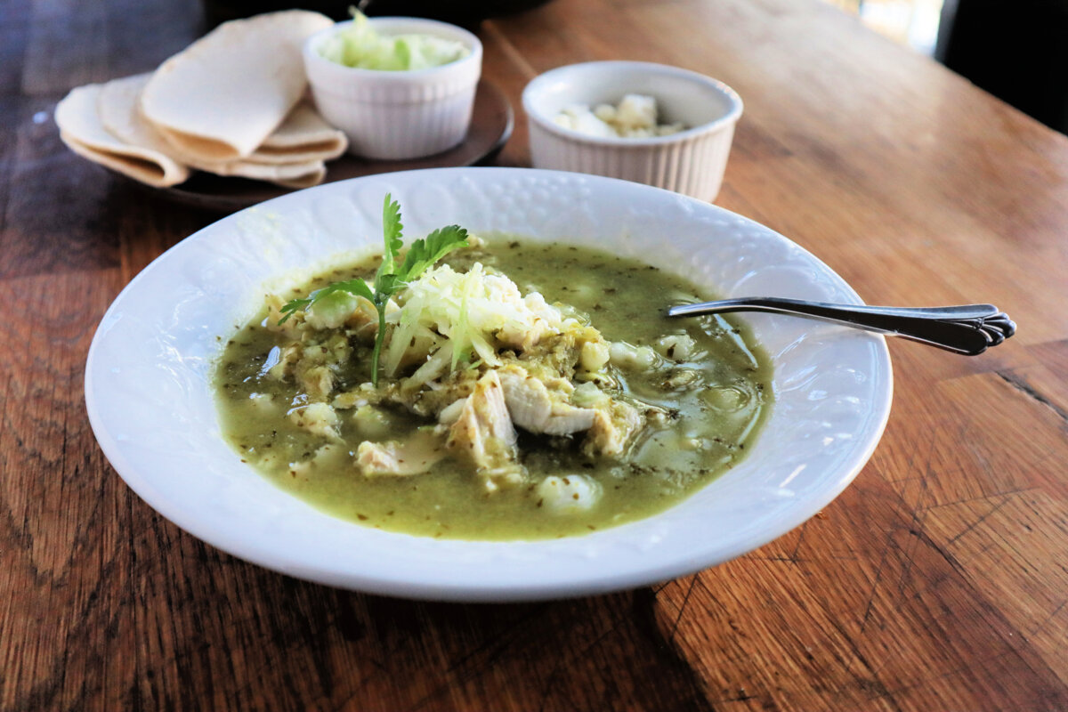 Pozole verde, a traditional Mexican stew, is made with shredded chicken and hominy in a tangy broth made from tomatillos and green chiles. (Gretchen McKay/Pittsburgh Post-Gazette/TNS)
