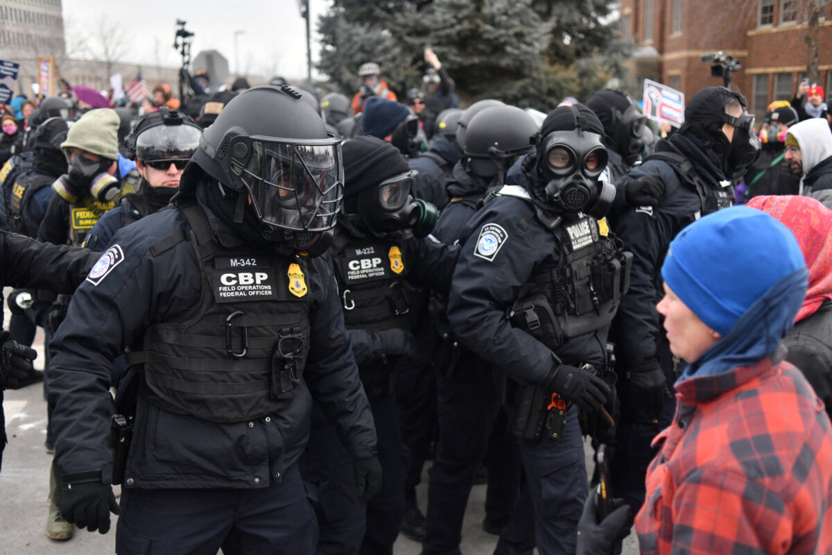 Federal agents stand in front of protesters in Minneapolis on Jan. 15, 2026. (Octavio Jones/AFP via Getty Images)