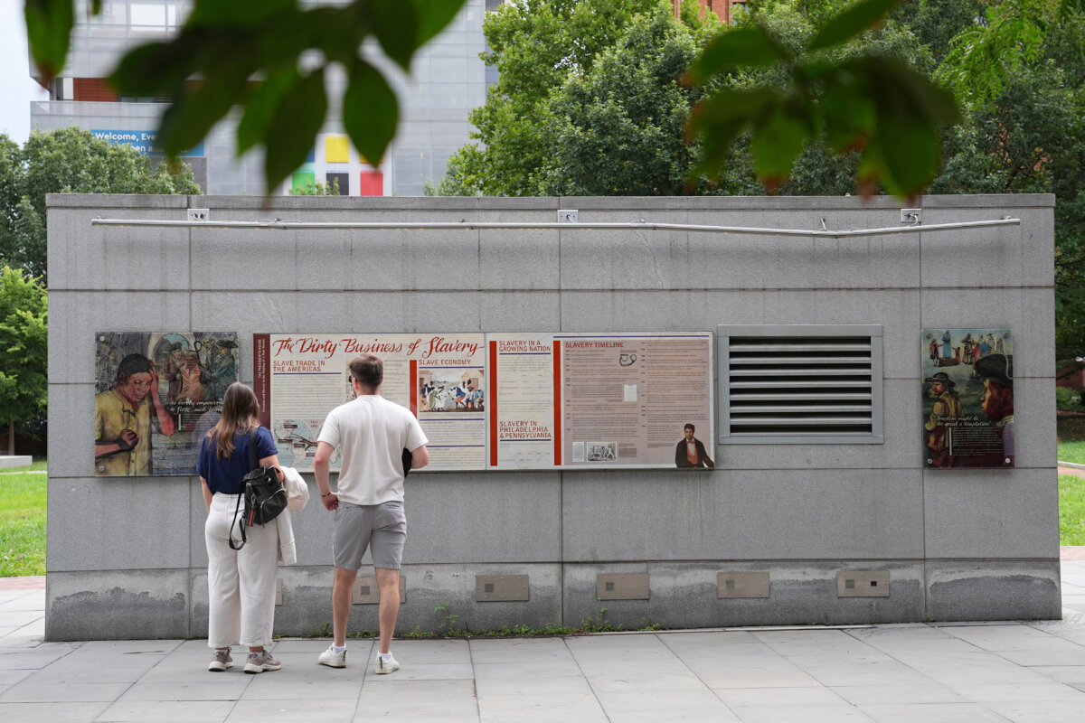People look at an informational panel at the President’s House site in Philadelphia on Aug. 19, 2025. (Matt Rourke/AP Photo)