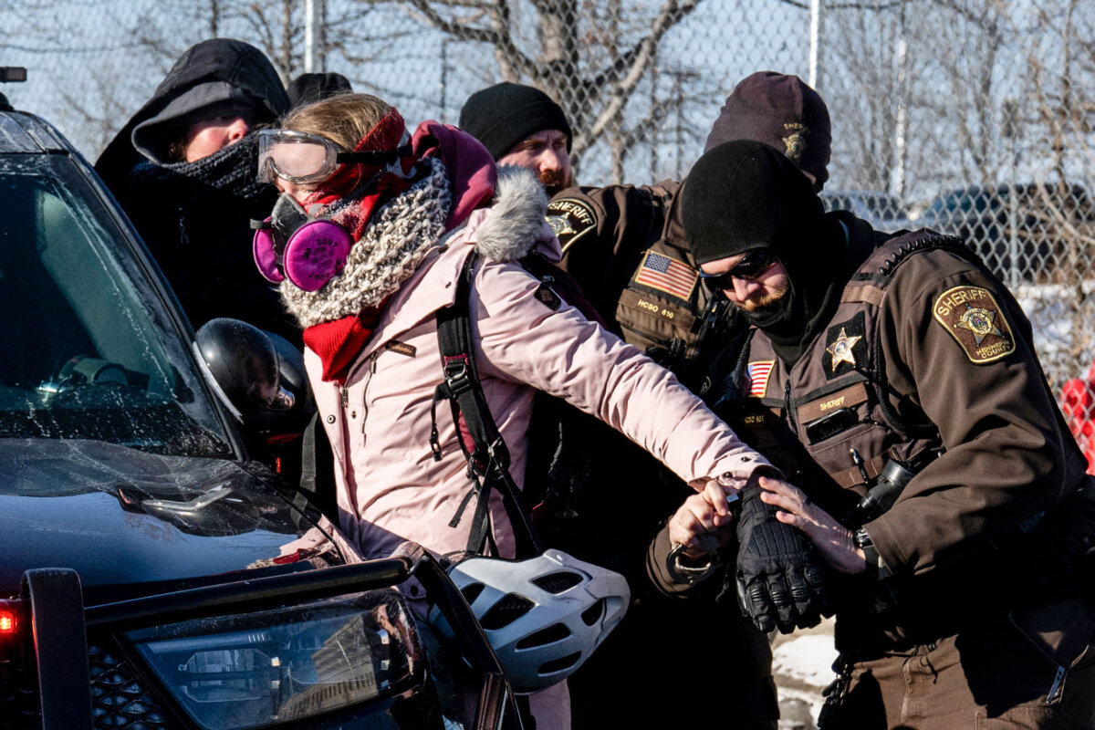An activist is arrested by officers of the Hennepin County Sheriff's Office after some protesters attempted to block the street in front of the Bishop Henry Whipple Federal Building during the "ICE out of Minnesota: Day of Truth and Freedom" protest in Minneapolis on Jan. 23, 2026. (Roberto Schmidt/AFP via Getty Images)