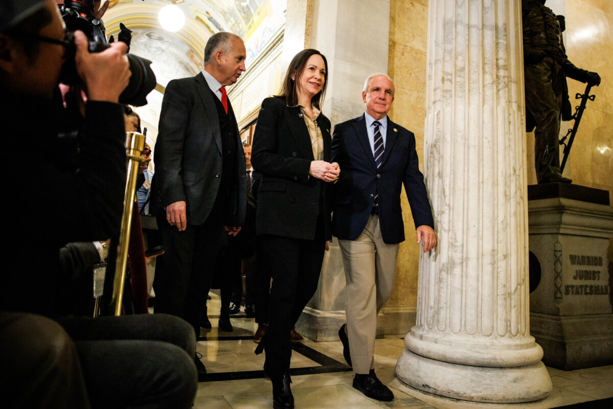 (L–R) U.S. Rep. Mario Díaz-Balart (R-Fla.), Venezuelan opposition leader Maria Corina Machado, and U.S. Rep. Carlos Gimenez (R-Fla.) walk over to speak to reporters after a closed door meeting at the U.S. Capitol on Jan. 20, 2026. (Samuel Corum/Getty Images)