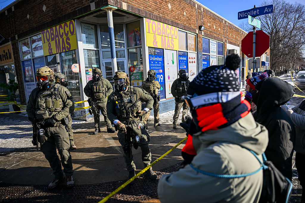 Onlookers gather after federal agents shot an armed suspect amid a scuffle to disarm him in Minneapolis, Minn., on Jan. 24, 2026. (Brandon Bell/Getty Images)