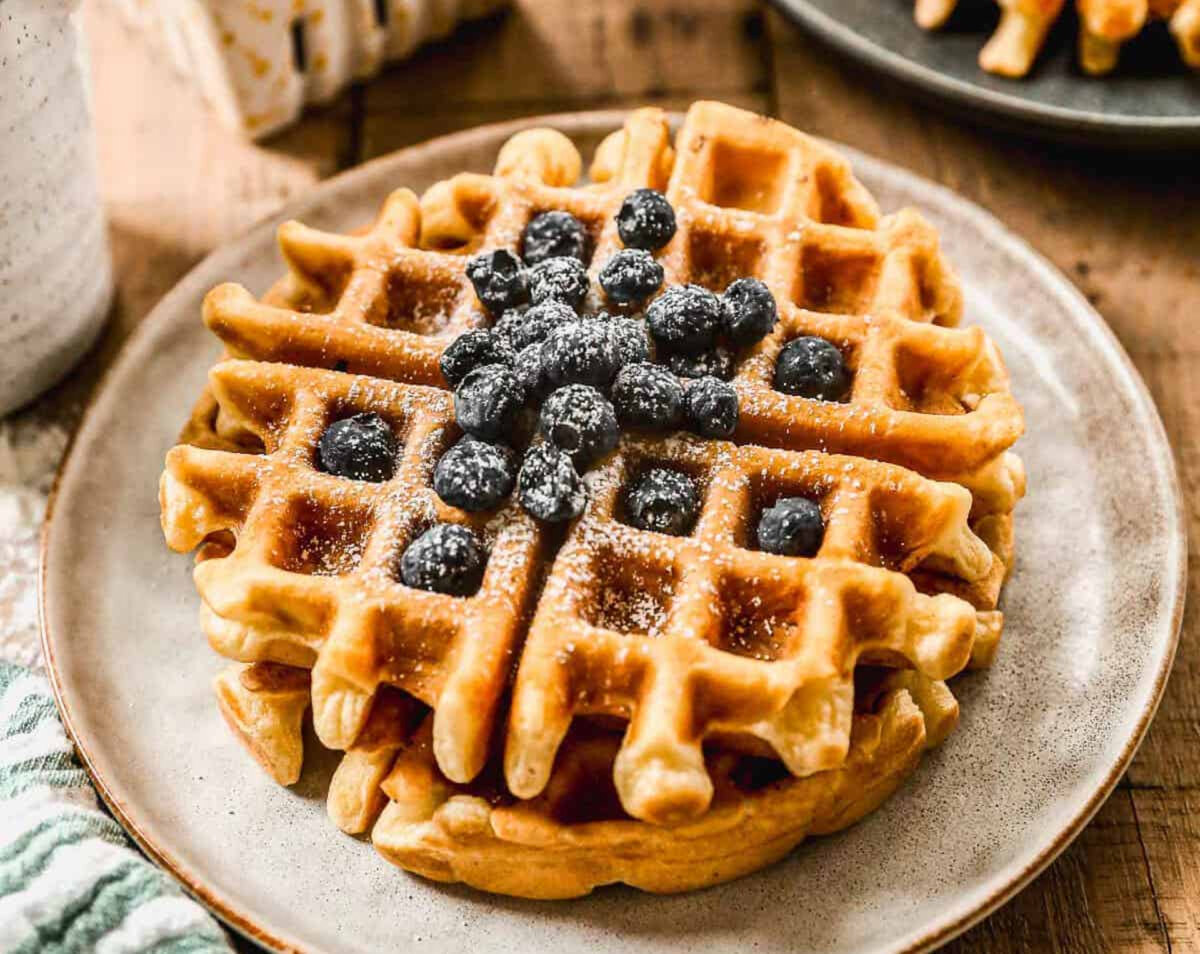 Our homemade Belgian Waffle recipe is restaurant-quality with a crispy exterior and a fluffy, tender center in just 15 minutes. They're EASY and made from scratch with simple ingredients. (Lauren Allen)