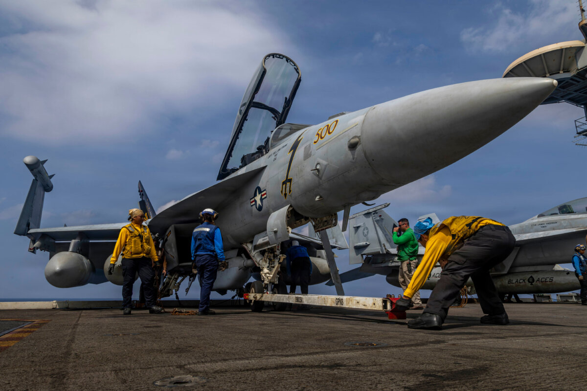 Sailors preparing a Boeing EA-18G Growler on the flight deck of the aircraft carrier USS Abraham Lincoln in the Indian Ocean on Jan. 21, 2026. (Mass Communication Specialist Seaman Daniel Kimmelman/U.S. Navy via AP)