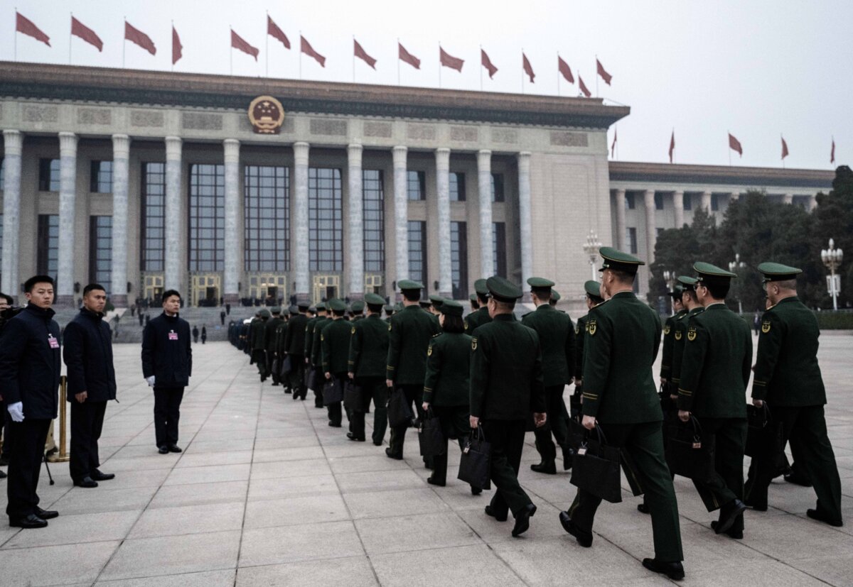 Delegates from the Chinese military walk together as they arrive at the closing session of China's rubber-stamp legislature, the National People's Congress, at the Great Hall of the People in Beijing on March 11, 2025. (Kevin Frayer/Getty Images)