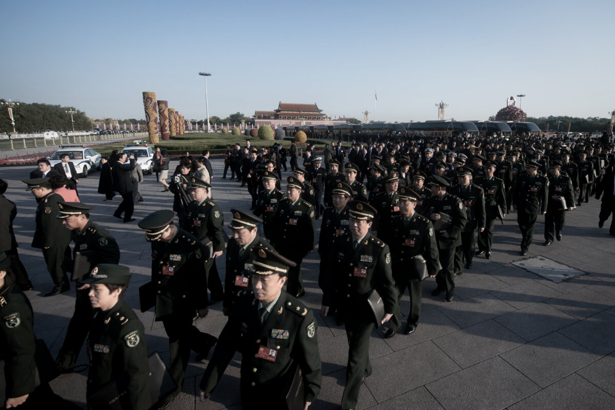 Military delegates walk on Tiananmen Square as they arrive at the opening session of the Chinese Communist Party's five-yearly Congress at the Great Hall of the People in Beijing on Nov. 8, 2012. (Ed Jones/AFP via Getty Images)