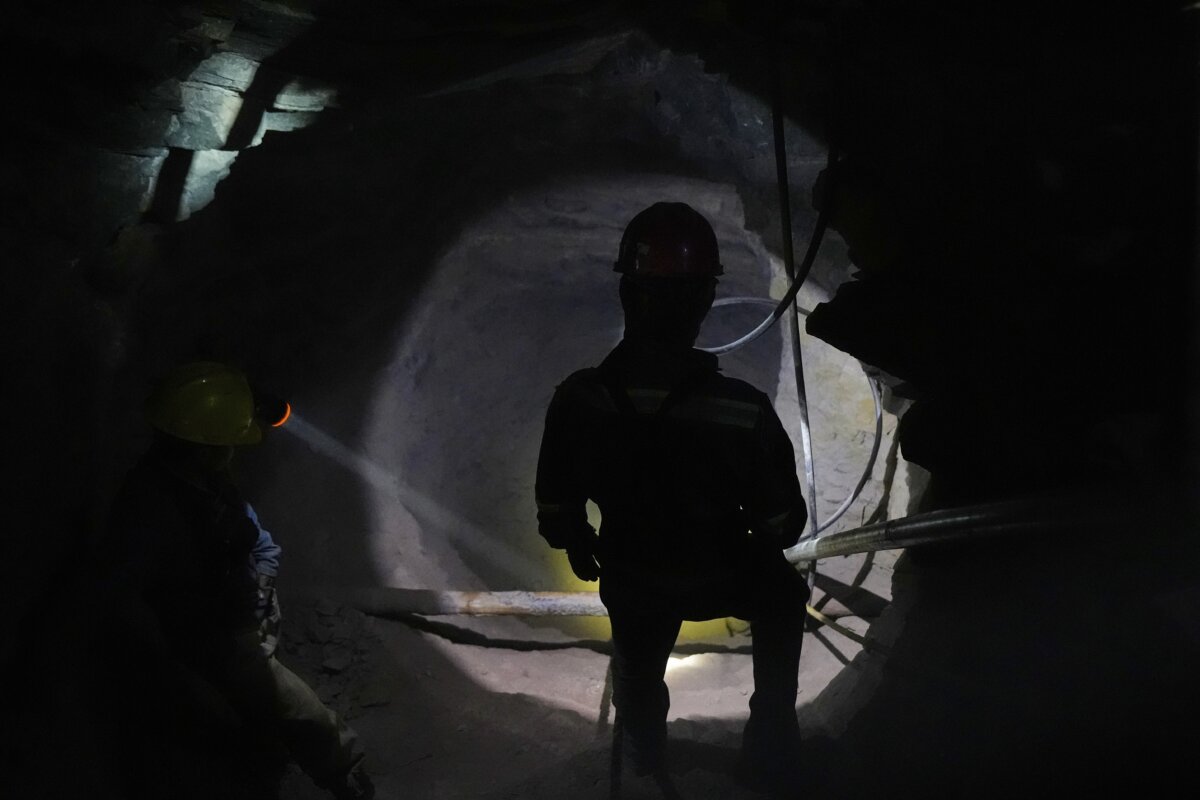 A miner lights up one of the caverns so that his colleagues can see the way out San Joaquin, Mexico, on Aug. 19, 2025. (Fernando Llano/AP Photo)