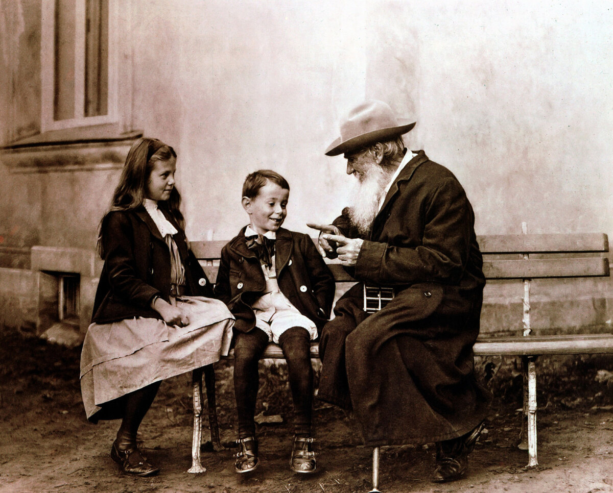 Leo Tolstoy telling a story to two of his grandchildren. (Photos.com/Getty Images)
