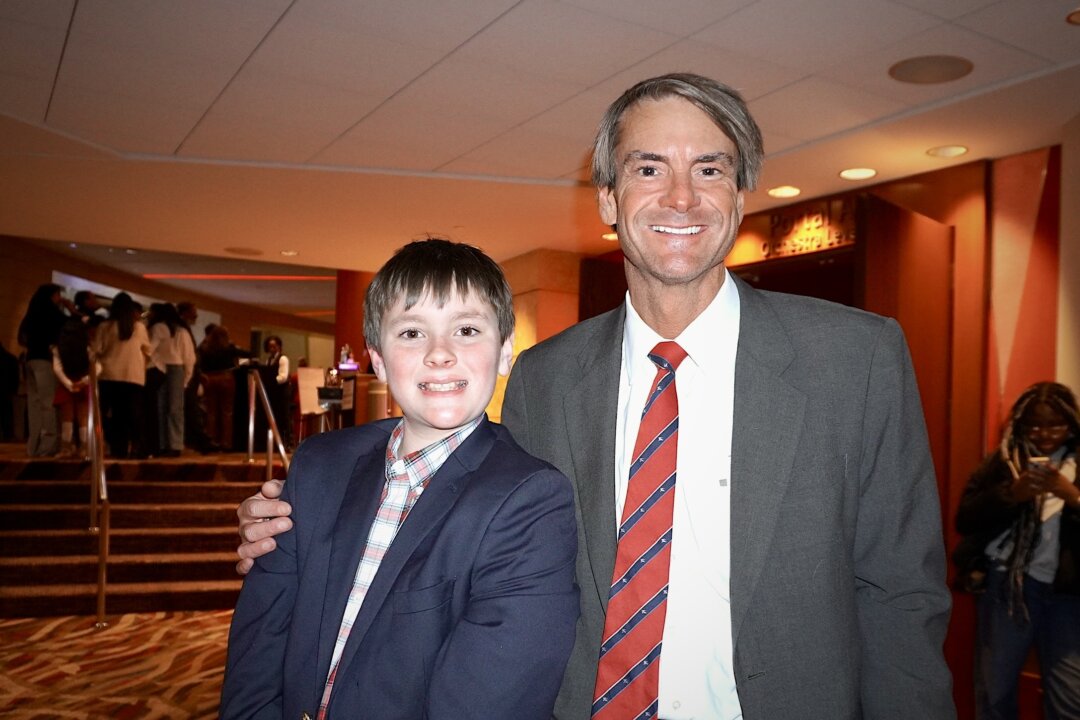 Austin Hooper (L) and his dad, Brian Hooper, attend Shen Yun at the Cobb Energy Performing Arts Centre in Atlanta on Jan. 30, 2026. (Sherry Dong/The Epoch Times)