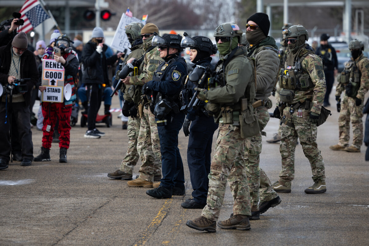 Protestors face-off with Department of Homeland Security personnel in front of the Bishop Henry Whipple Federal Building in Minneapolis, MN., on Jan. 9, 2026. (John Fredricks/The Epoch Times)