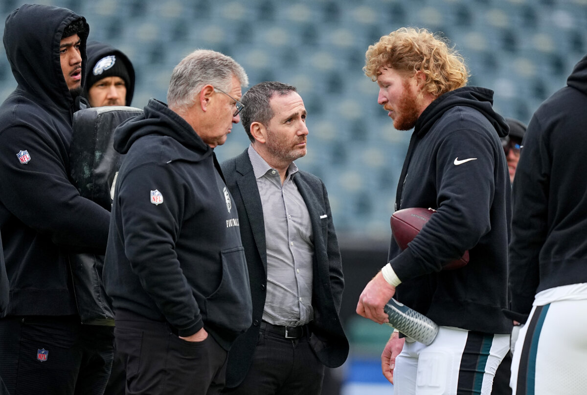 (L-R) Offensive line coach Jeff Stoutland, General manager Howie Roseman and Cam Jurgens #51 of the Philadelphia Eagles talk on the field prior to the NFC Championship Game against the Washington Commanders at Lincoln Financial Field in Philadelphia, on Jan. 26, 2025. (Mitchell Leff /Getty Images)