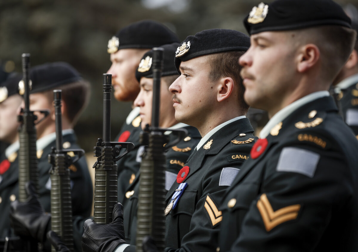 Members of the King’s Own Calgary Regiment present arms during a graveside ceremony honouring Cpl. Gawen Foster, who served with the 50th Canadian Infantry Battalion, Canadian Expeditionary Force, during the First World War, in Calgary on Nov. 9, 2025. (The Canadian Press/Jeff McIntosh)