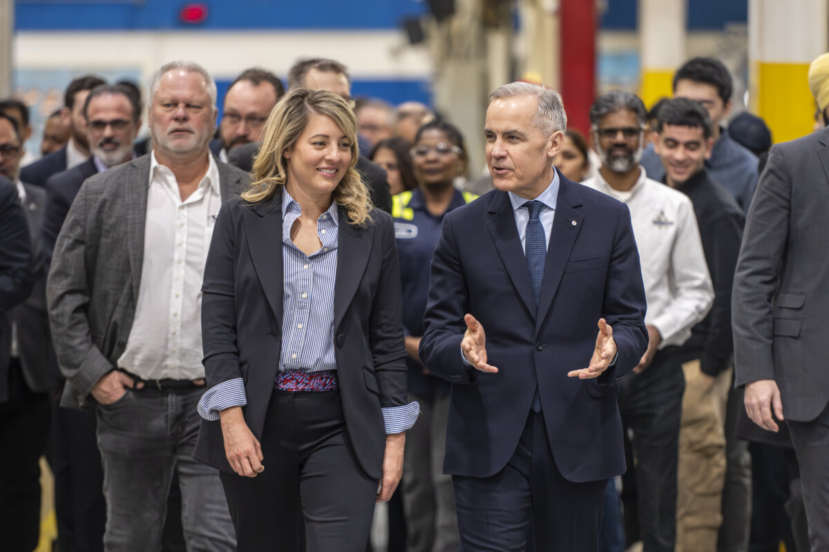 Prime Minister Mark Carney walks with Industry Minister Mélanie Joly as they arrive for a visit to an auto-parts plant in Woodbridge, Ont., on Feb. 5, 2026. (The Canadian Press/Eduardo Lima)
