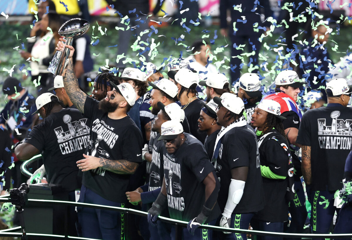 Seattle Seahawks players celebrate with the Vince Lombardi Trophy after defeating the New England Patriots during Super Bowl LX at Levi's Stadium in Santa Clara, Calif., on Feb. 8, 2026. (Patrick T. Fallon/AFP via Getty Images)