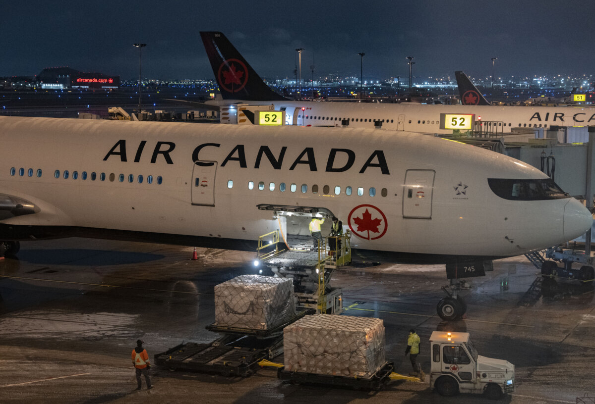 Cargo is loaded onto an Air Canada plane at Montreal-Pierre Elliott Trudeau International Airport in Montreal on Nov. 30, 2025. (The Canadian Press/Christinne Muschi)
