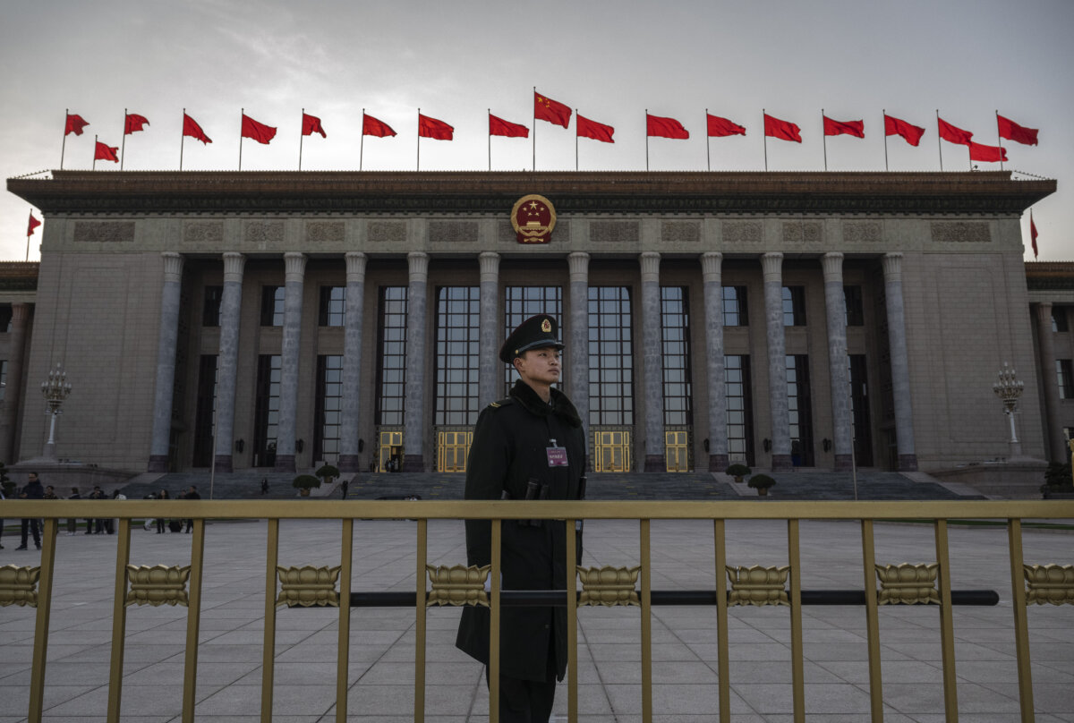 A member of the Peoples Armed Police stands at the entrance of the National Peoples Congress at the Great Hall of the People during delegation meetings in Beijing, China, on March 6, 2024. (Kevin Frayer/Getty Images)