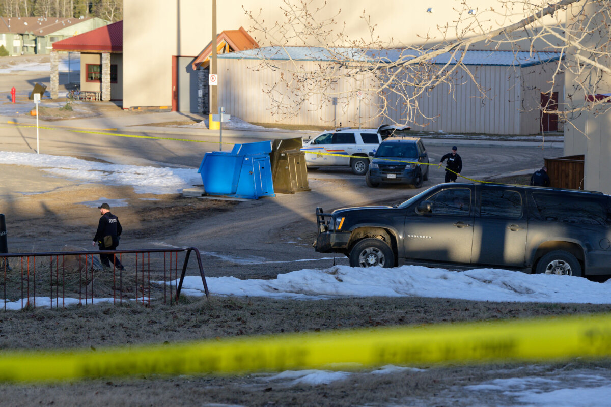Police officers are seen outside Tumbler Ridge Secondary School after a mass shooting, in Tumbler Ridge, B.C., on Feb. 11, 2026. (The Canadian Press/Jesse Boily)