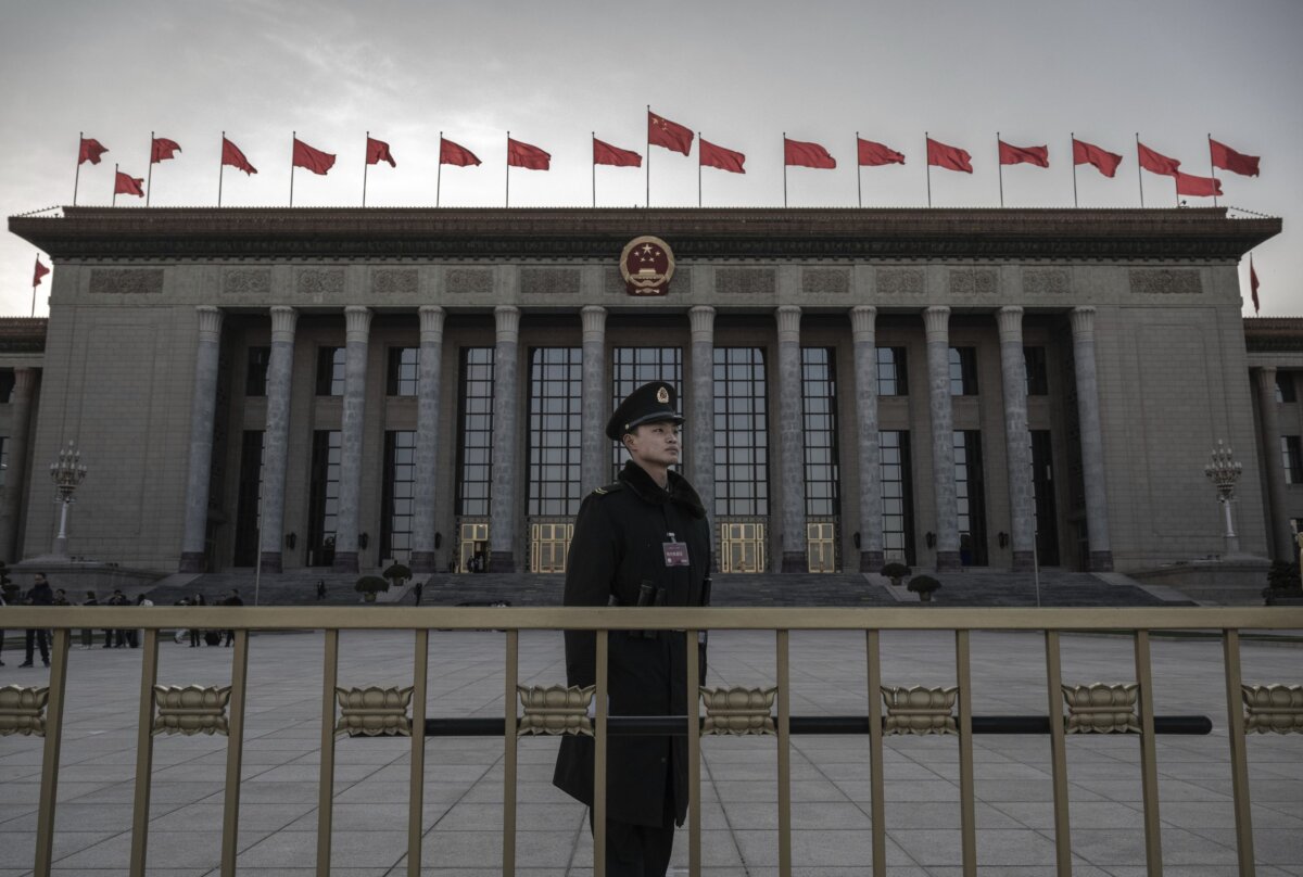 A member of the Peoples Armed Police stands at the entrance of the National Peoples Congress at the Great Hall of the People during delegation meetings on March 6, 2024 in Beijing, China. (Kevin Frayer/Getty Images)