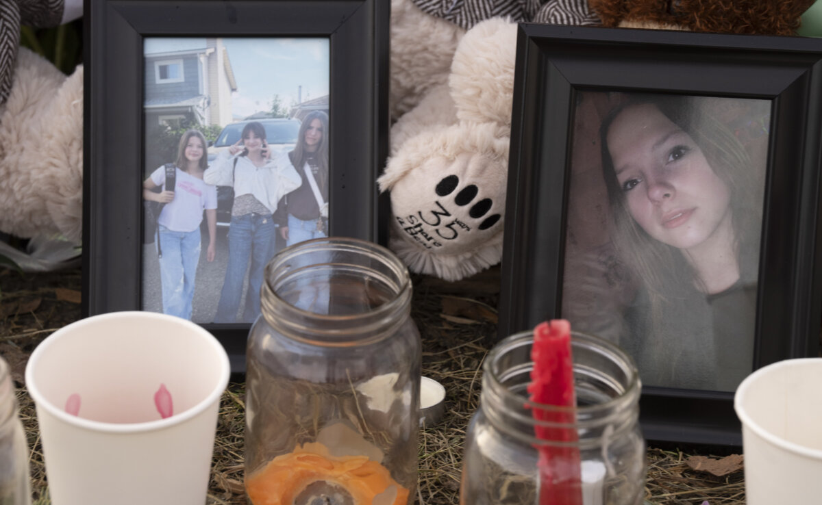 Photos of victims are seen at a memorial in Tumbler Ridge, B.C., on Feb. 12, 2026. (The Canadian Press/Christinne Muschi)