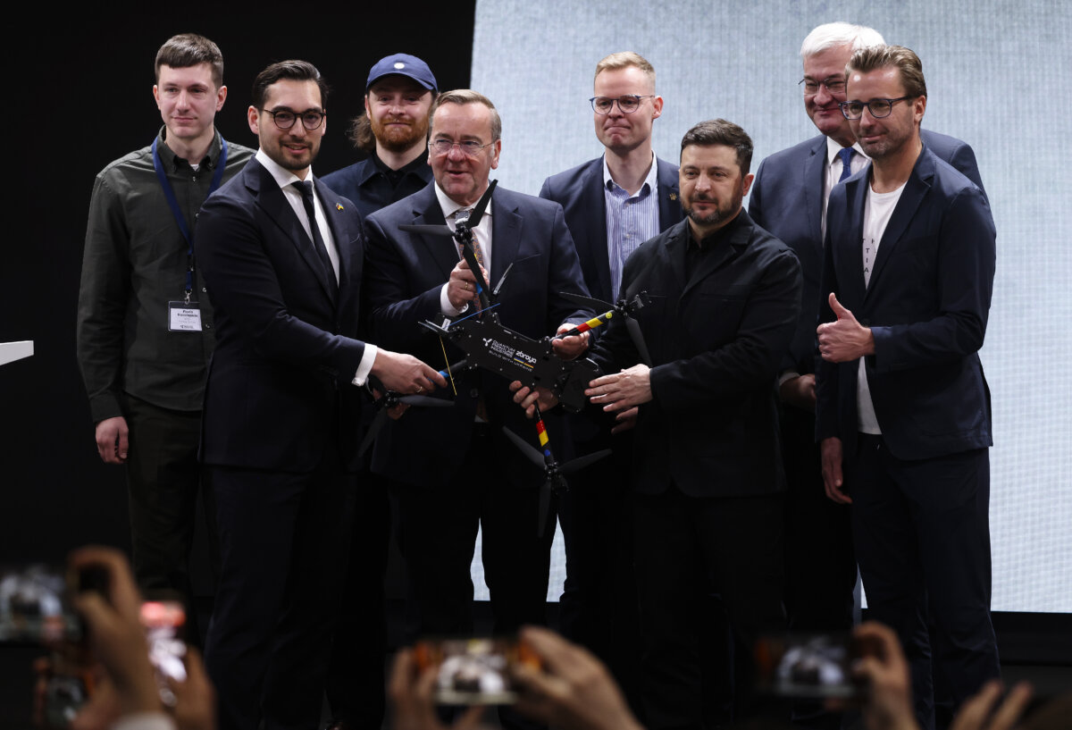 Ukrainian President Volodymyr Zelenskyy (3rd R) and German Defense Minister Boris Pistorius (C) hold a "Linza" drone while visiting Quantum Frontline Industries' plant near Munich on Feb. 13, 2026. (Sean Gallup/Getty Images)