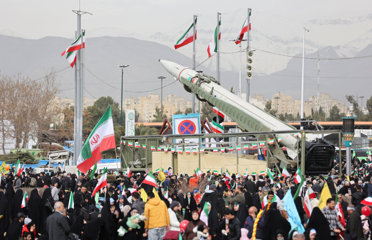 People gather near a missile on display during the 47th anniversary of the Islamic Revolution in Tehran, Iran, on Feb. 1, 2026. (Majid Asgaripour/WANA via Reuters)