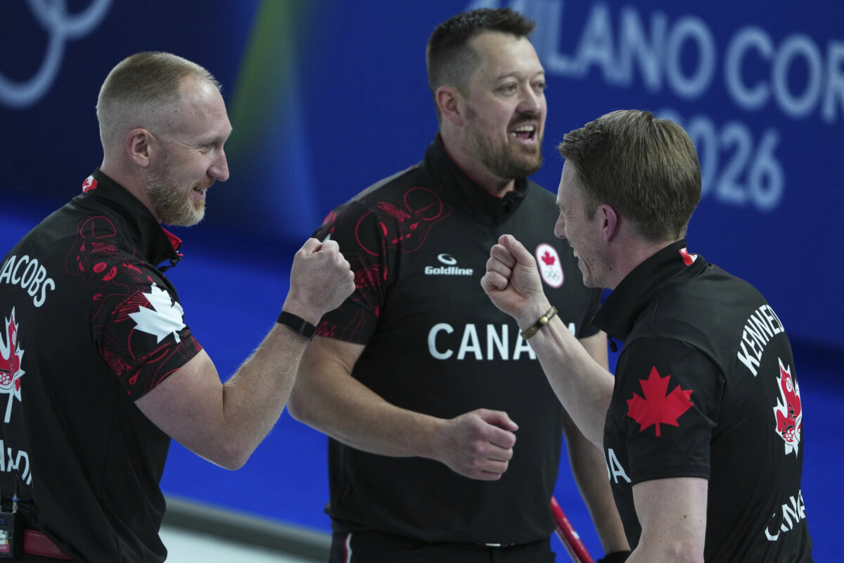Canada’s Marc Kennedy, Brad Jacobs, and Ben Hebert react after the men’s curling round robin session against Sweden at the 2026 Winter Olympics in Cortina d'Ampezzo, Italy, on Feb. 13, 2026. (AP Photo/Misper Apawu)
