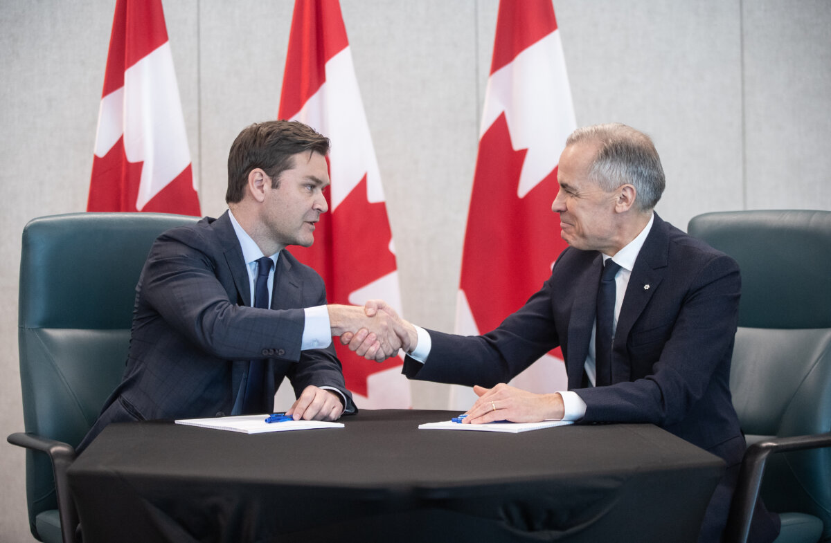 Prime Minister Mark Carney and MP Matt Jeneroux meet in Edmonton after Jeneroux crossed the floor to join the Liberals on Feb. 18, 2026. (The Canadian Press/Jason Franson)