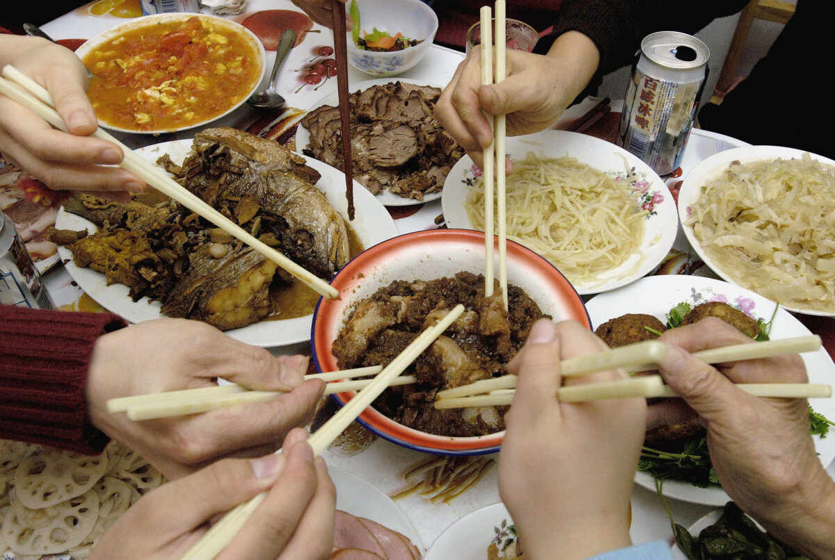 Chinese family members eat their New Year's Eve dinner in Beijing on Feb. 8, 2005. (China Photos/Getty Images)