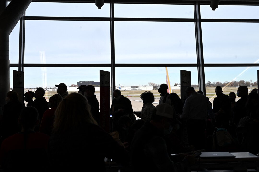 Travelers wait ahead of the Thanksgiving holiday at St. Louis Lambert International Airport, Mo., on Nov. 22, 2021. (Robyn Beck/AFP via Getty Images)