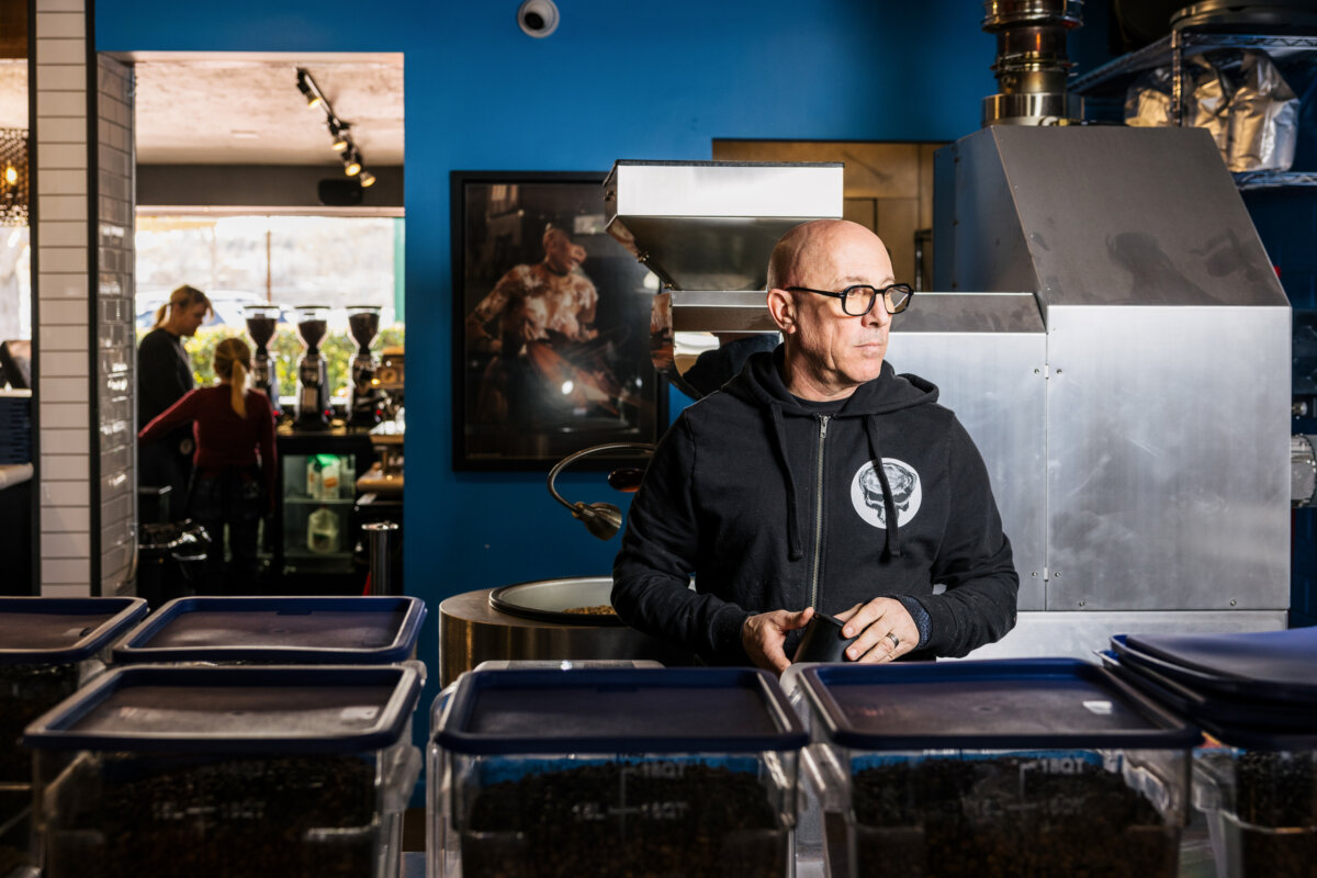 Maynard James Keenan brews coffee at Queen B Vinyl Café, which he co-owns with his wife, Jennifer Keenan, in Cottonwood, Ariz., in August 2025. (Courtesy of Grace Stufkosky/Queen B Vinyl Café)