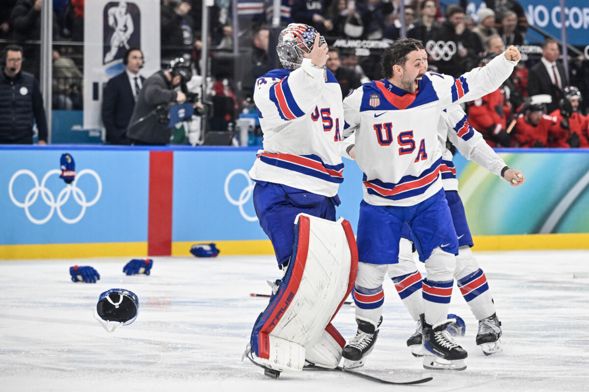 U.S. players celebrate winning the men's gold medal ice hockey match between Canada and USA at the Milano Santagiulia Ice Hockey Arena during the Milano Cortina 2026 Winter Olympic Games in Milan, Italy, on Feb. 22, 2026. (Alexander Nemenov/AFP via Getty Images)