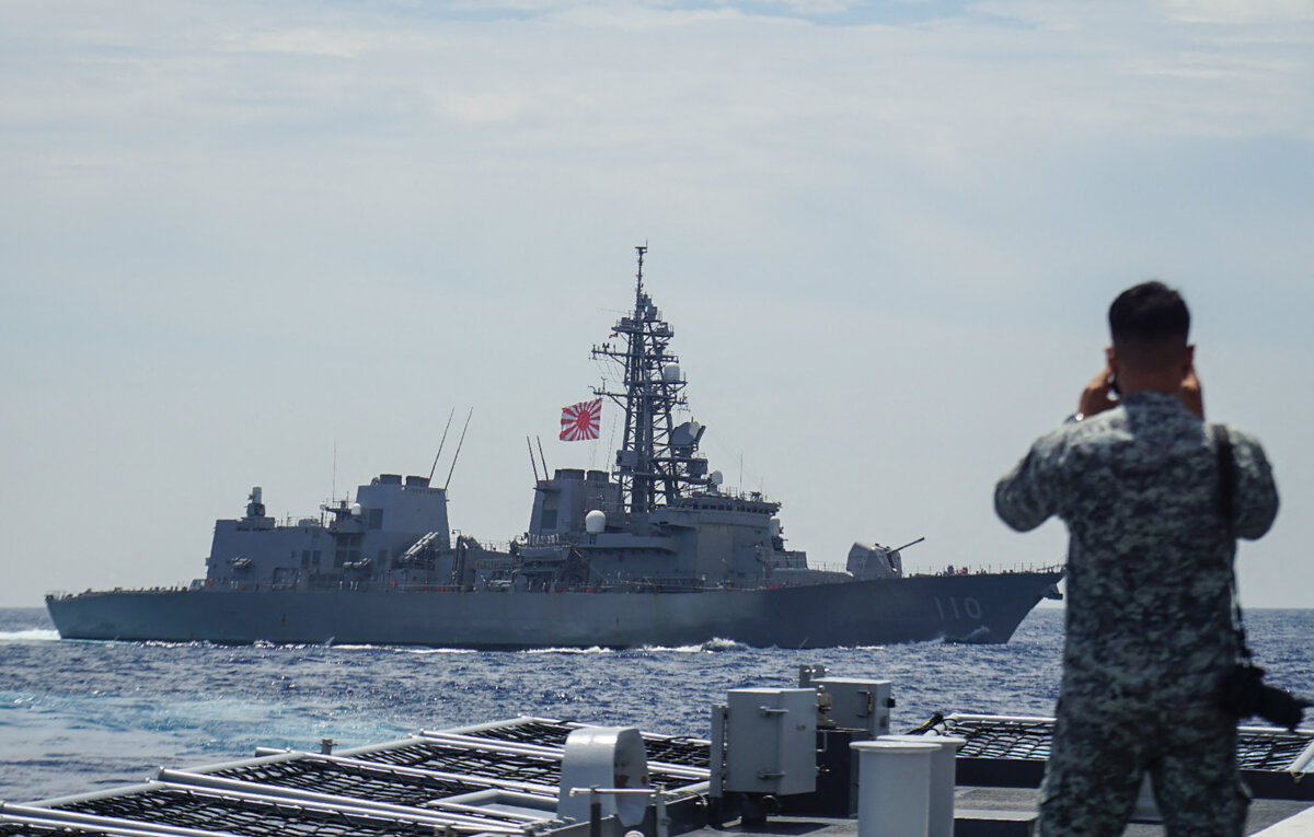 A member of the Philippine Navy looks out at the Japan Maritime Self-Defense Force's destroyer Takanami during a joint maritime exercise in the South China Sea on June 14, 2025. (STR/JIJI Press/AFP via Getty Images)