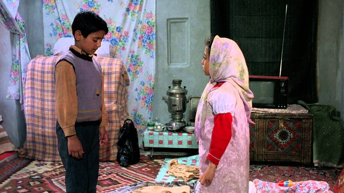 Ali (Amir Farrokh Hashemian) dotes on his 6-year-old sister, Zahra (Bahare Seddiqi), in “Children of Heaven.” (Miramax)