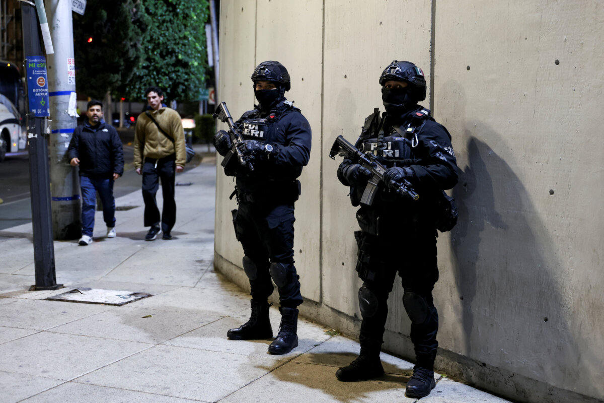 Security personnel stand guard outside the Specialized Prosecutor's Office for Organized Crime (FEMDO), where the body of El Mencho is suspected of being held by authorities, after a military operation in which a government source said Mexican drug lord Nemesio Oseguera, known as "El Mencho," was killed in Jalisco state, in Mexico City on Feb. 22, 2026. (Luis Cortes/Reuters)
