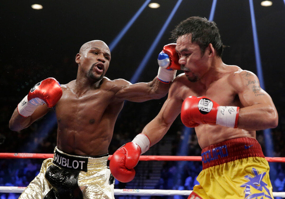 Floyd Mayweather Jr. (L) hits Manny Pacquiao, from the Philippines, during their welterweight title fight in Las Vegas on May 2, 2015. (Isaac Brekken/AP Photo)