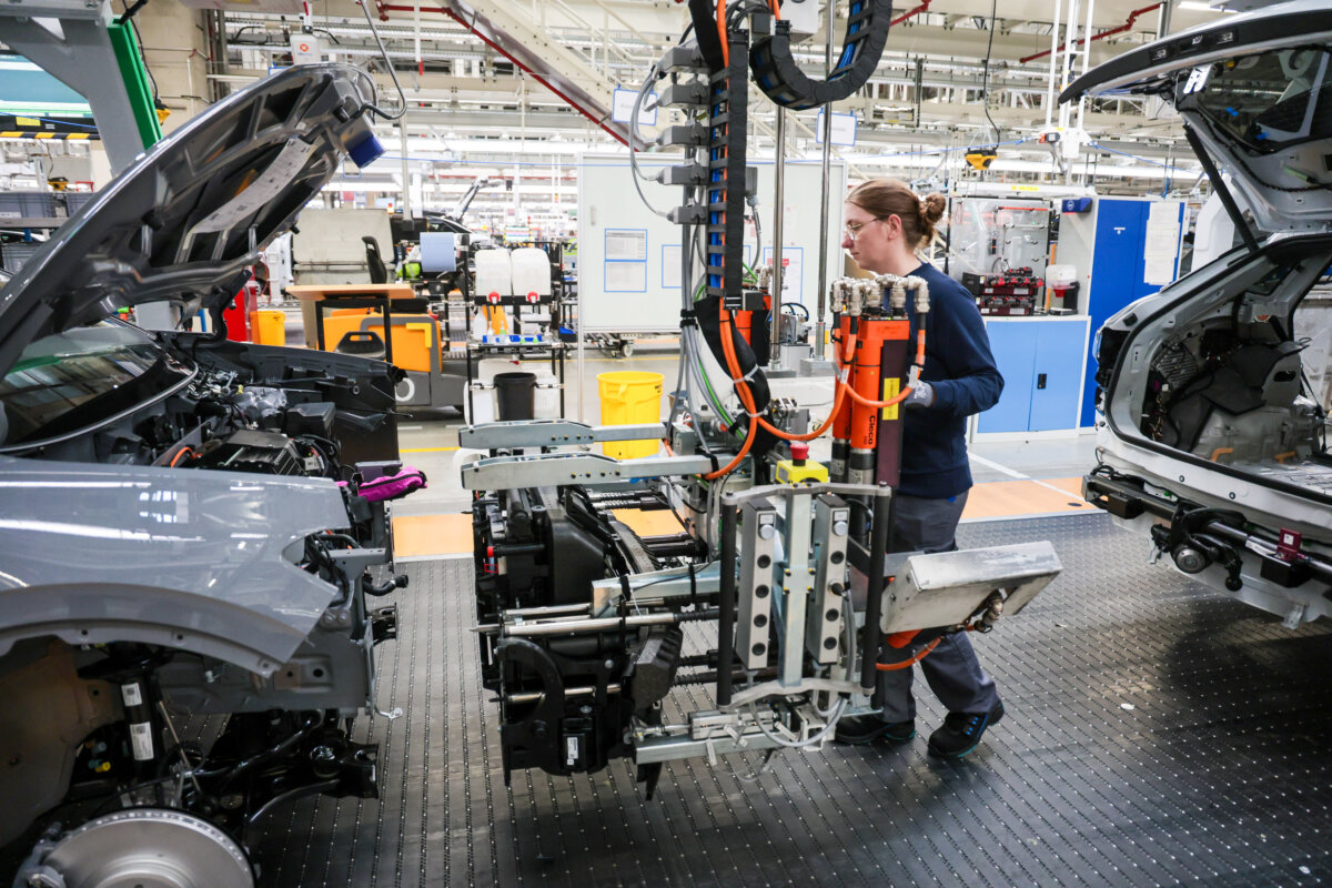Volkswagen assembly worker Jasmin Artmann attaches the front panel to an ID line electric car at the Volkswagen electric car factory in Emden, Germany, on Feb. 24, 2026. (Focke Strangmann/Getty Images)