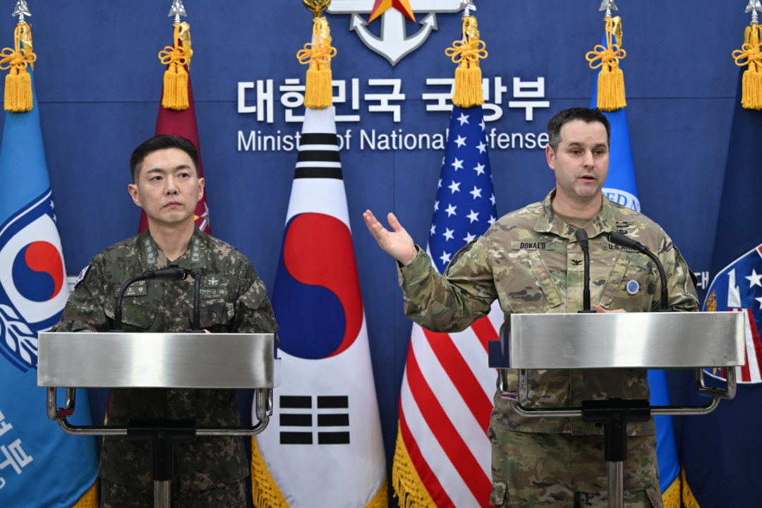 Col. Jang Do-young (L) public affairs director of South Korea's Joint Chiefs of Staff, and U.S. Army Col. Ryan Donald (R), public affairs director of the United Nations Command, Combined Forces Command, and United States Forces Korea, pose for a photo during a media briefing on the 2026 ROK-US Freedom Shield Military Exercise at the Defense Ministry in Seoul, South Korea, on Feb. 25, 2026. (Jung Yeon-je/Pool Photo via AP)
