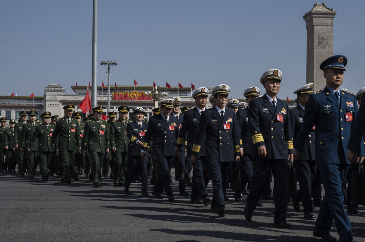 Adm. Wang Renhua (L-3) and other military delegates arrive at the closing session of China's rubber-stamp legislature, the National People's Congress, in Beijing on March 11, 2024. (Kevin Frayer/Getty Images)