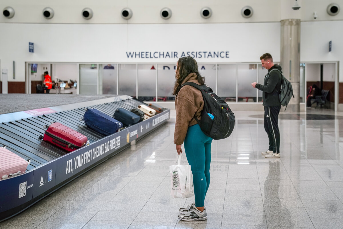 Passengers are seen in the Delta Air Lines baggage claim area at Hartsfield-Jackson Atlanta International Airport on Jan. 25, 2026, in Atlanta, United States. A massive winter storm is bringing frigid temperatures, ice, and snow to nearly 200 million Americans. (Elijah Nouvelage/Getty Images/TNS)