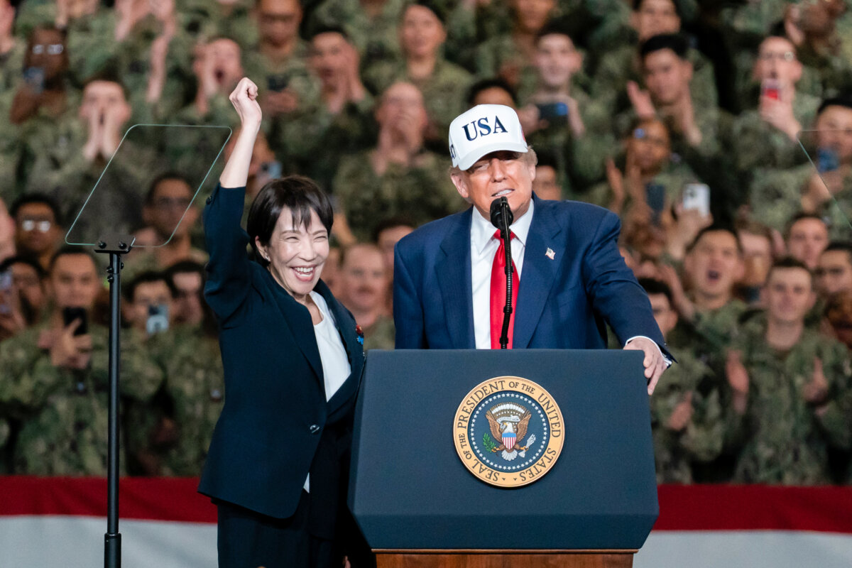 Japanese Prime Minister Sanae Takaichi raises her fist as U.S. President Donald Trump speaks aboard USS George Washington on Oct. 28, 2025, in Yokosuka, Japan. (Tomohiro Ohsumi/Getty Images)