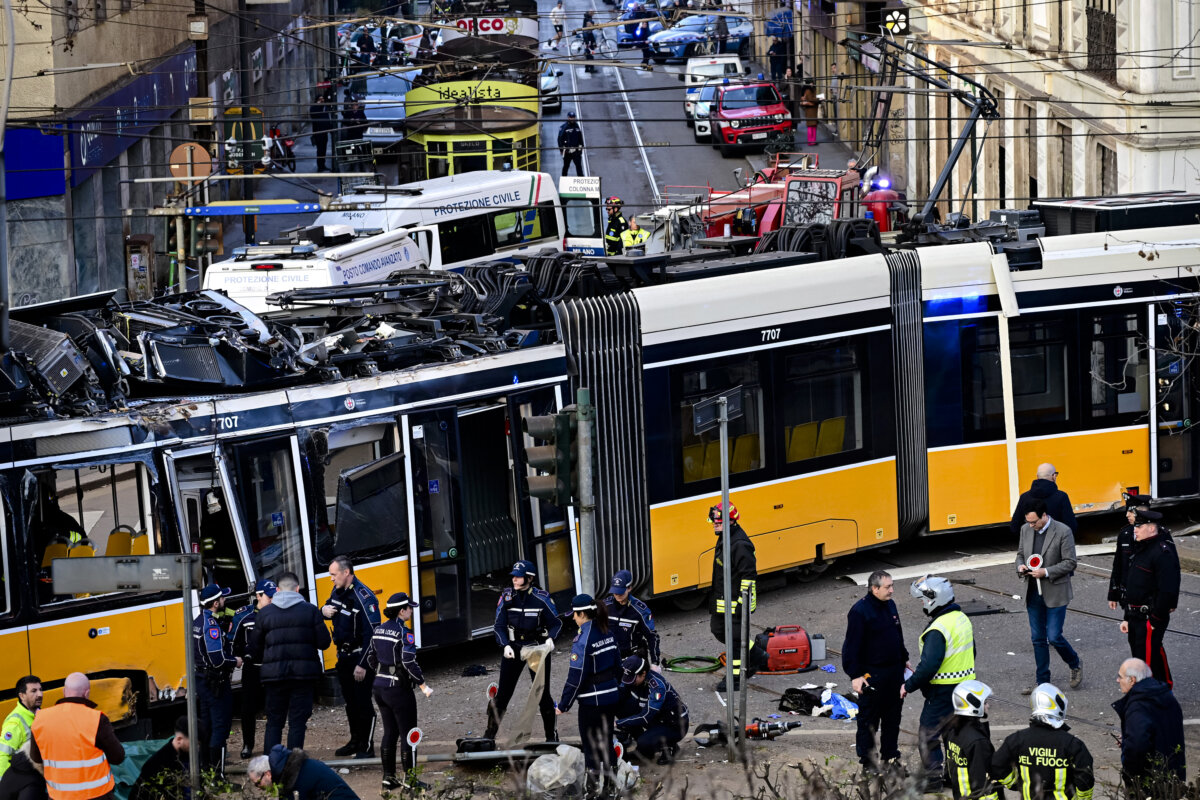 Italian police officers and firefighters operate at the site of a tram derailment in Milan on Feb. 27, 2026. A tram derailed and smashed into a building in Milan on February 27, 2026, killing one person and injuring around 20 others, the police told AFP. (Piero Cruciatti/AFP via Getty Images)